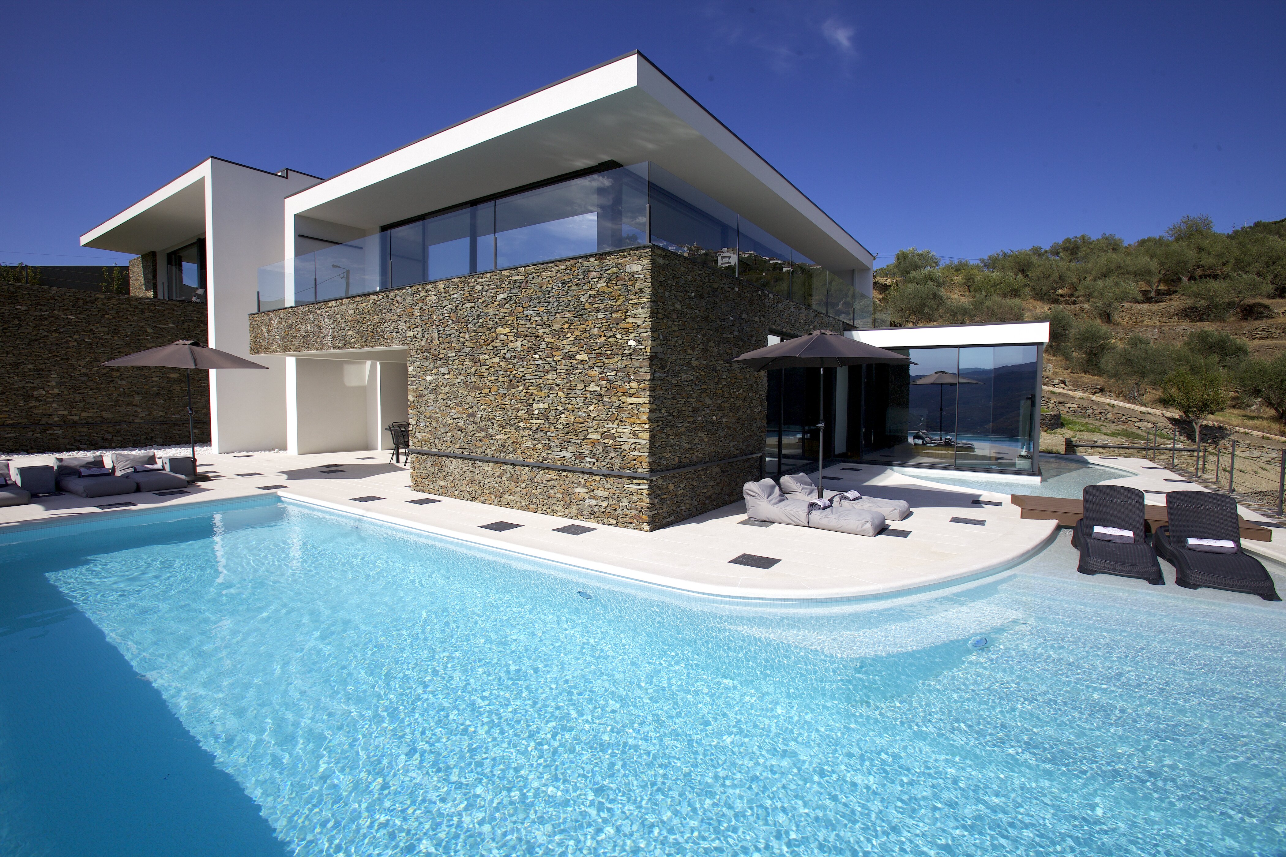 Pool terrace also showing room with Jacuzzi