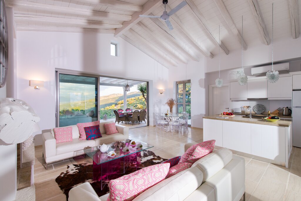 Open plan sitting room with kitchen and dining area opening to terrrace