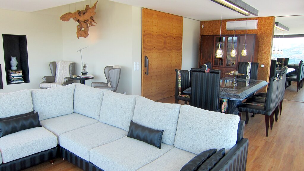 Open plan sitting room with TV and dining area