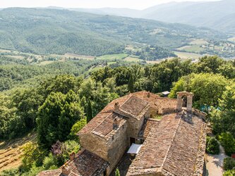 Magnificent panoramic views from the valley - showing paved courtyard area below and lawned areas to left and right