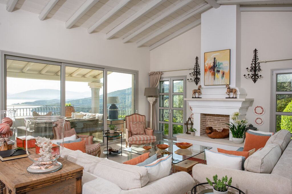 Large sitting room with fireplace opening onto front and back terraces