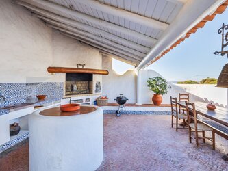 Outdoor barbecue area facing the pool