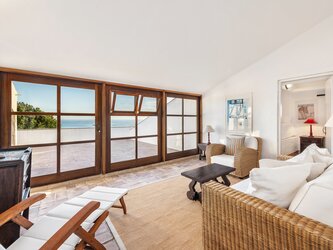 First floor living room opening onto terrace with sea views